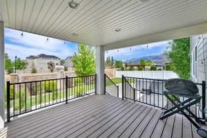 Deck featuring a fenced backyard, a mountain view, and a residential view