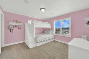 Carpeted bedroom with baseboards