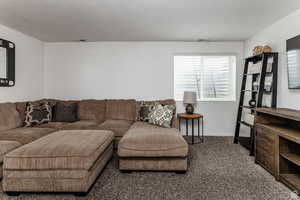 Carpeted living area with baseboards