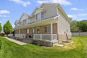 View of front of property featuring covered porch and brick siding