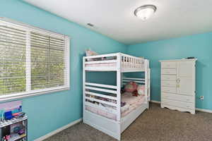 Carpeted bedroom featuring baseboards