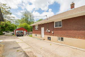 Driveway featuring separate entrance to downstairs unit
