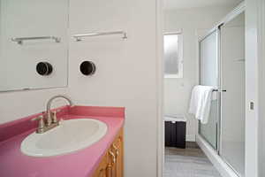 Full bath featuring vanity, wood finished floors, and a shower stall