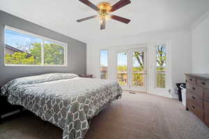 Carpeted bedroom with ornamental molding, ceiling fan, and access to exterior