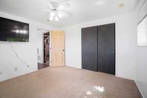 Unfurnished bedroom with baseboards, a closet, and carpet