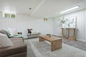 Great room area featuring wood like floors and built in shelving