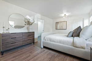 Primary Bedroom with wood finished floors and baseboards