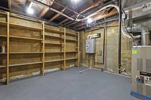Unfinished basement featuring tankless water heater