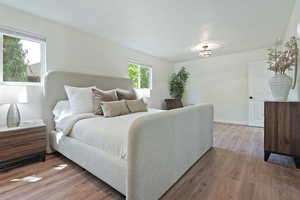 Primary Bedroom featuring  wood-style flooring and baseboards
