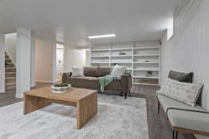 Great room area featuring wood like floors and built in shelving
