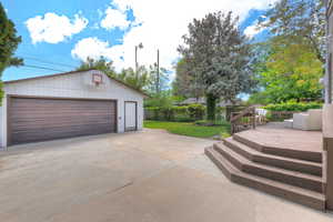 Backyard with large wood deck and Oversized 2 car garage with workshop & Storage