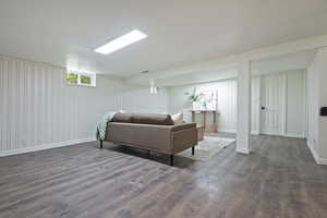 Great room area featuring wood like floors and built in shelving