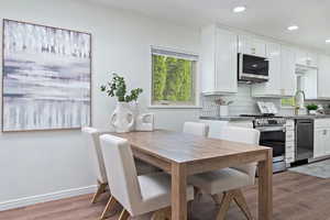 Dining area with wood finished floors, recessed lighting, and baseboards