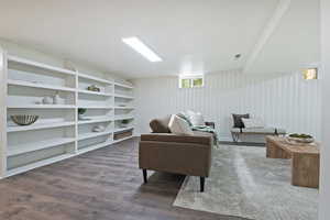 Great room area featuring wood like floors and built in shelving