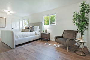 Primary Bedroom with baseboards and wood finished floors