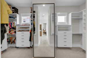 Spacious closet featuring marble look tiles