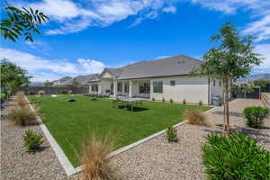 Rear view of property with stucco siding and a tile roof