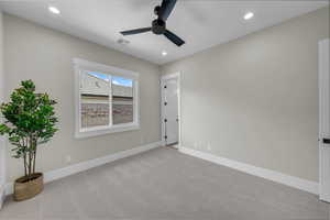 Spare room featuring a ceiling fan, light carpet, baseboards, and recessed lighting