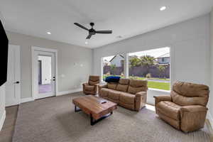 Living room featuring ceiling fan, recessed lighting, baseboards, and wood finished floors