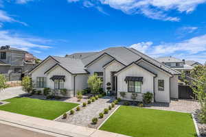 Modern farmhouse featuring stone siding, board and batten siding, and a tiled roof
