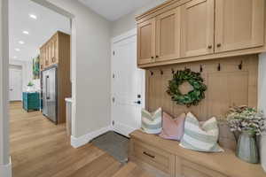 Mudroom with light wood-style floors, baseboards, and recessed lighting