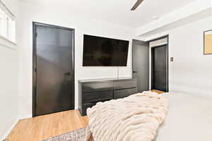 Bedroom featuring hardwood flooring, a ceiling fan, and bedroom closet
