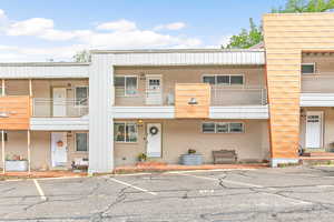 View of front of condo with parking space