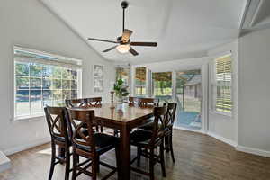 Dining area with baseboards, plenty of natural light, vaulted ceiling, and ceiling fan