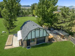 View of poultry coop featuring a lawn and a mountain view