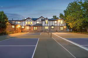 View of tennis court with basketball hoop