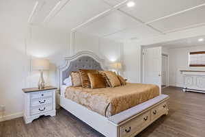 Bedroom featuring baseboards, dark wood-style floors, coffered ceiling, and recessed lighting