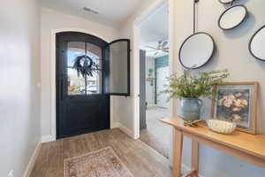 Foyer featuring baseboards, a ceiling fan, and wood finished floors