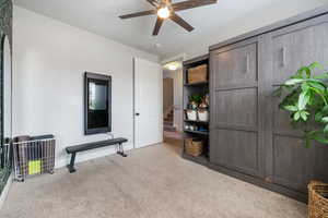 Carpeted bedroom featuring arched walkways, baseboards, and ceiling fan