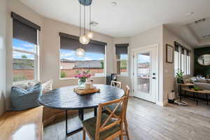 Dining space with light wood finished floors and baseboards