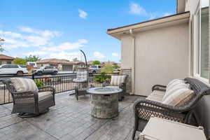 View of patio / terrace with an outdoor fire pit and a residential view