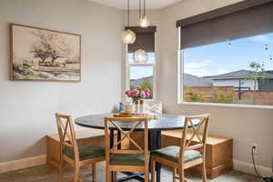 Dining area featuring baseboards, wood finished floors, and breakfast area