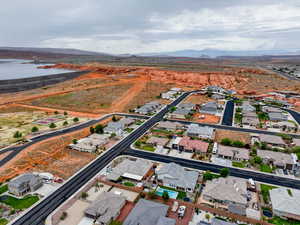 Aerial overview of property's location with a water and mountain view and nearby suburban area