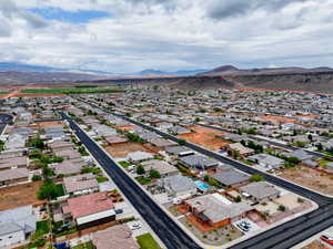 Aerial perspective of suburban area featuring a mountain backdrop