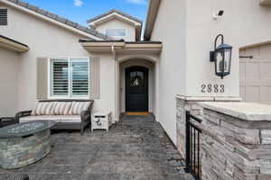 Doorway to property featuring stucco siding