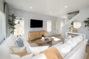 Living area featuring light wood-type flooring, baseboards, and recessed lighting