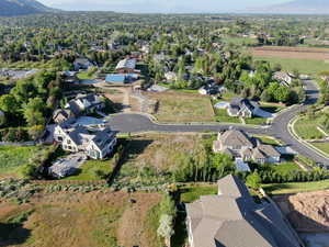 Aerial view of property's location with nearby suburban area and a mountain backdrop