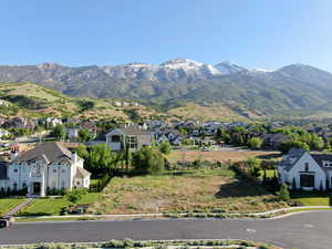 View of mountain backdrop featuring nearby suburban area