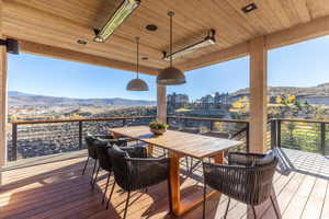 Deck featuring a mountain view and outdoor dining area