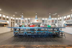 Bar featuring decorative light fixtures and recessed lighting