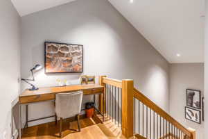 Office space with wood finished floors and recessed lighting