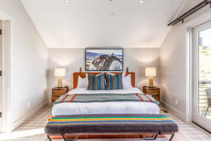 Carpeted bedroom featuring vaulted ceiling, baseboards, and access to outside