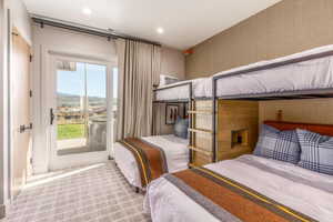 Carpeted bedroom with access to exterior and a mountain view
