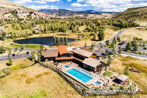 Aerial view of a pool area and a water and mountain view