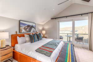 Carpeted bedroom featuring lofted ceiling