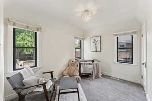 Sitting room with baseboards, a notable chandelier, carpet flooring, and visible vents